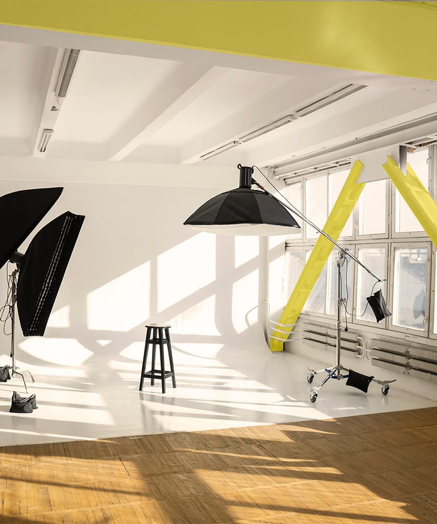 Professional lighting equipment, flashes, c-stands on a cyclorama in modern photo studio with a huge windows. Octabox, stripbox, softbox, buety plate and other stuff for photography. Professional lighting equipment, flashes, c-stands on a cyclorama in modern photo studio with a huge windows. Octabox, stripbox, softbox, buety plate and other stuff for photography
